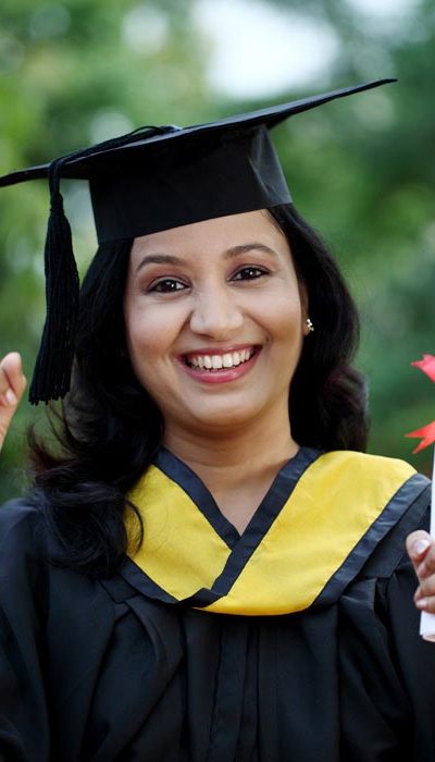 Young female student with diploma at outdoors