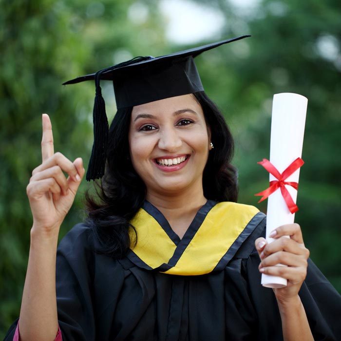 Young female student with diploma at outdoors